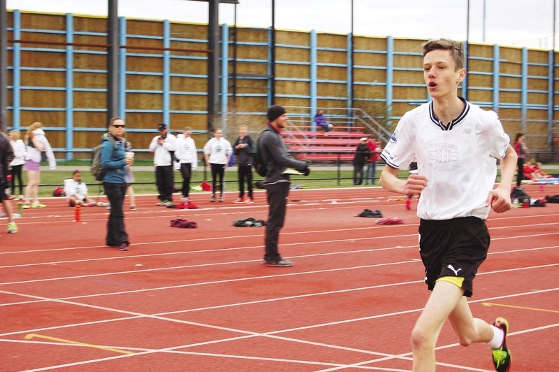 St. Timothy School Thunder&#8217;s Alex Howells eats up the track May 15 at Calgary&#8217;s Foothills Athletic Park en route to qualifying for the Calgary Senior High School