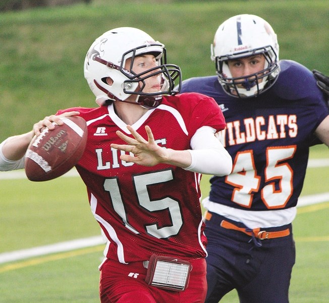 Lions quarterback Des Catellier prepares to unload a pass against Wildcats. He pitched two TDs and ran for another in the game.