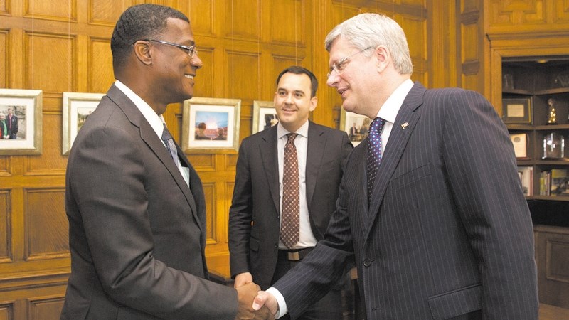 Dr. Rufus Ewing, left, premier of Turks and Caicos, meets with Prime Minister Stephen Harper, right, and Wild Rose MP Blake Richards in the Prime Minister&#8217;s office.