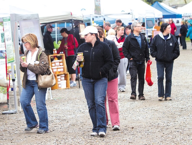 Shoppers peruse booths at Cochrane&#8217;s Farmers&#8217; Market last summer.