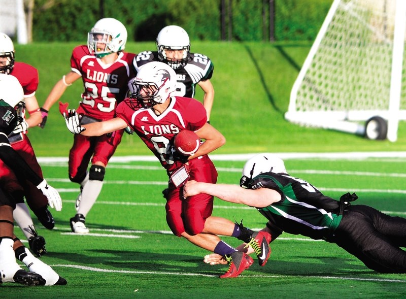 Cochrane Lions receiver Grayson Javorsky works for yards against Calgary Hilltoppers in Calgary Area Midget Football Association Div. 2 final play May 29 at Calgary&#8217;s