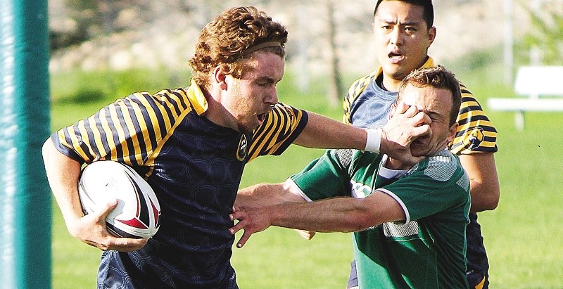Grizzlies&#8217; Joey Clarke grabs a face full of Irish in Calgary Rugby Union Div. 3 men&#8217;s play May 30 at Calgary Canadian Irish Athletic Club ground.