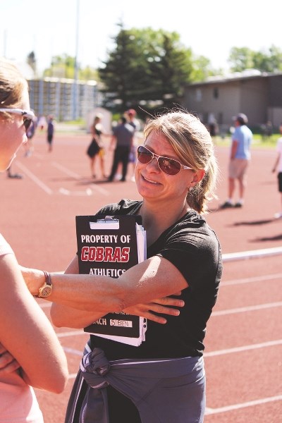 Cochrane High School track coach Esther Sieben checks in with assistant coaches and athletes at the Alberta Schools&#8217; Athletic Association (ASAA) South Central Zone
