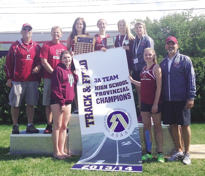 Cochrane High School Cobras display their Alberta Schools&#8217; Athletic Association 3A (Tier 2) provincial track championship banner June 7 at Foothills Athletic Park in