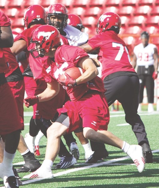 Stamps fullback Rob Cote makes an authoritative first cut at the line of scrimmage during Calgary Stampeders training camp June 12 at McMahon Stadium. Cochrane&#8217;s new