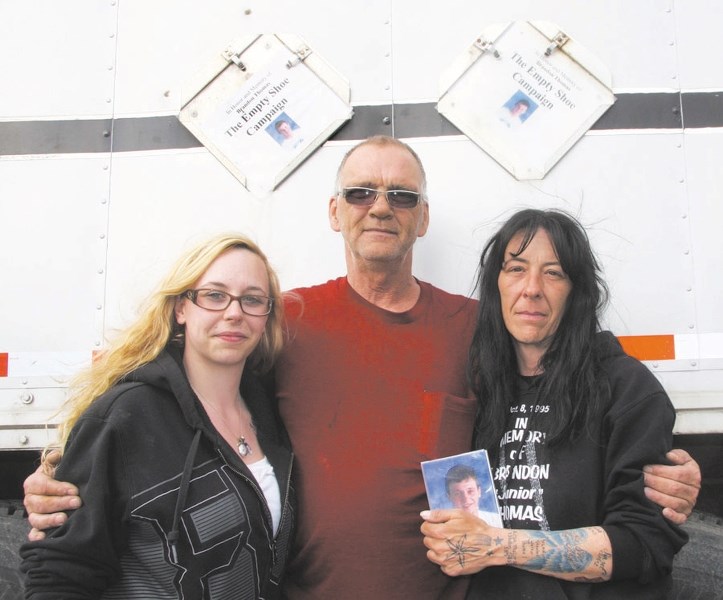 Kayla Thomas, left, and Kim Thomas, right, were thankful Ken Chester took the time to drive 610 pairs of donated shoes to Cochrane for the Empty Shoe Campaign June 14.