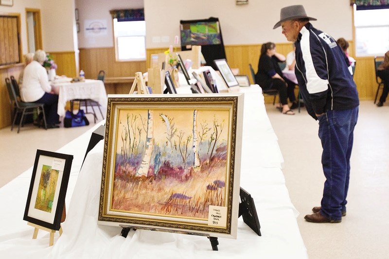Jack Robertson has a look at the artwork on display during a past Beaupre Artists&#8217; Guild Show and Sale. This year&#8217;s event will run from June 28-29.