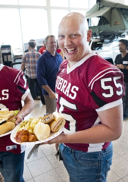 Cochrane High School Cobras centre Brock Wiebe bellies up to Spolumbo&#8217;s training table at the Cochrane Turf Gala June 21 at Cochrane Toyota. The event raised