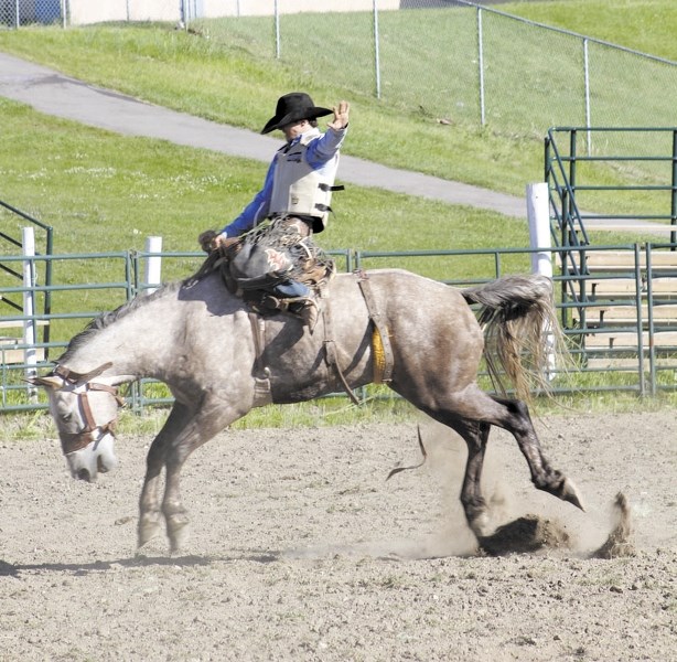 Lane Watt rides Scotch Tape during the second annual Foothills Bucking Horse Futurity July 11, 2013 at Cochrane Lions Rodeo Park. This year&#8217;s event will also be at
