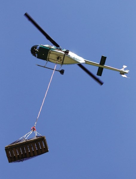 Out of the sky come net-loads of pre-fabricated trail infrastructure for installation June 19 at McLean Creek Public Land Use Zone by volunteer crews marshalled by the