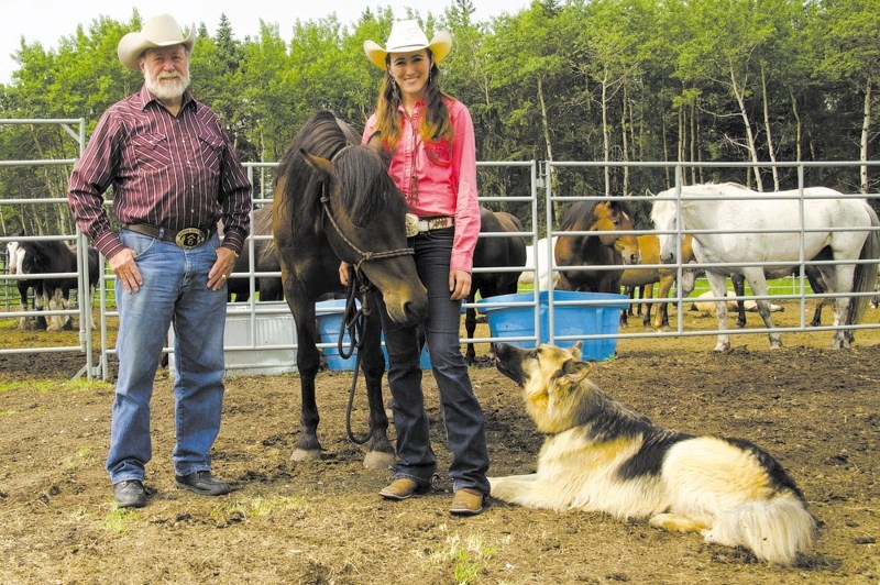 Stan Cowley and daughter Kateri Cowley stand on their new property with Kateri&#8217;s Cowboy Up Challenge winning horse, Kokane, and family dog, Cowboy. The Cowleys are