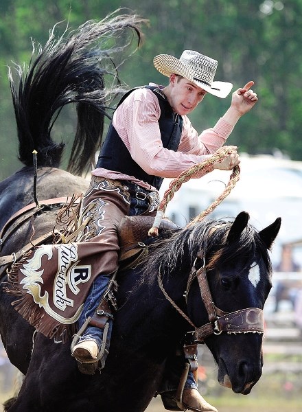 Cochrane saddle bronc rider Keenan Reinhardt rides hard at the 109th annual Dogpound Rodeo on July 16 in Dogpound. Reinhardt&#8217;s 74 score won at the Foothills Cowboy