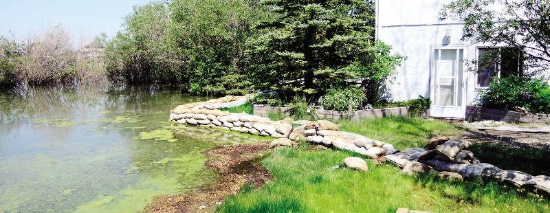 This is the home of Jill Breeck, who lives at 92 Cochrane Lake Trail and has been watching Cochrane Lake creep closer and closer to her home with no sign of letting up on