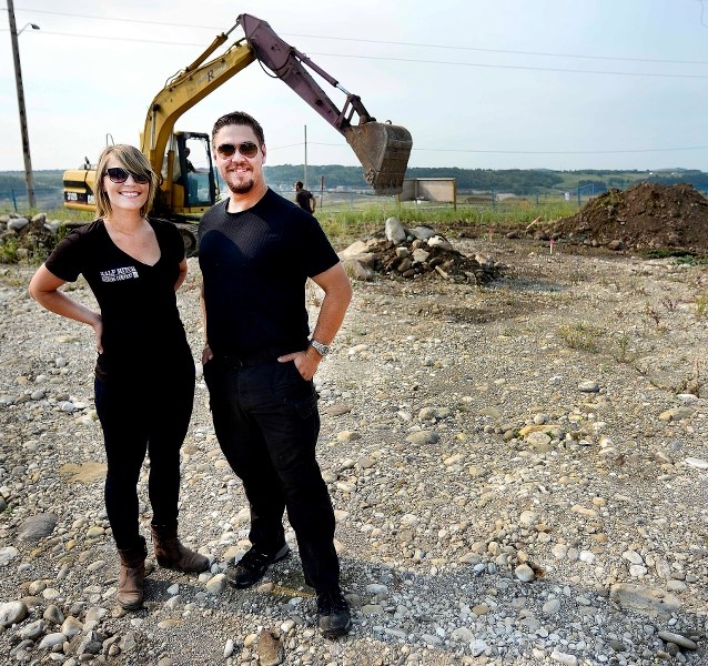 Britt Kozloski (left) and Chris Heier stand on the ground being prepared for Cochrane&#8217;s Half Hitch Brewery being constructed at the corner of Griffin Road and Griffin