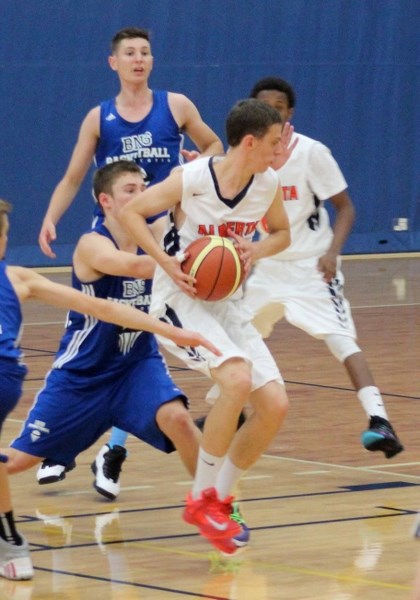 Cochrane Cobras&#8217; Jake Nielson of Team Alberta works the ball against Nova Scotia at the under-16-year-old (U16) regional boy&#8217;s basketball tournament July 26 in