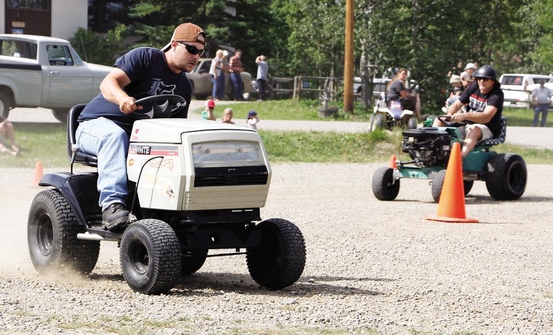Marty Deeves of Cochrane leads into the first turn at the Water Valley Days lawn tractor races Aug. 10 in Water Valley. Deeves won the modified event on his 1980&#8217;s