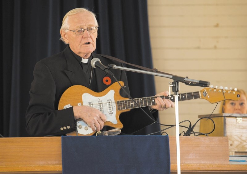 Reverend John W. Friesen (performing during a Remembrance Day ceremony at the Morley United Church) will work with a group from the Aylmer Baptist Church to renovate the