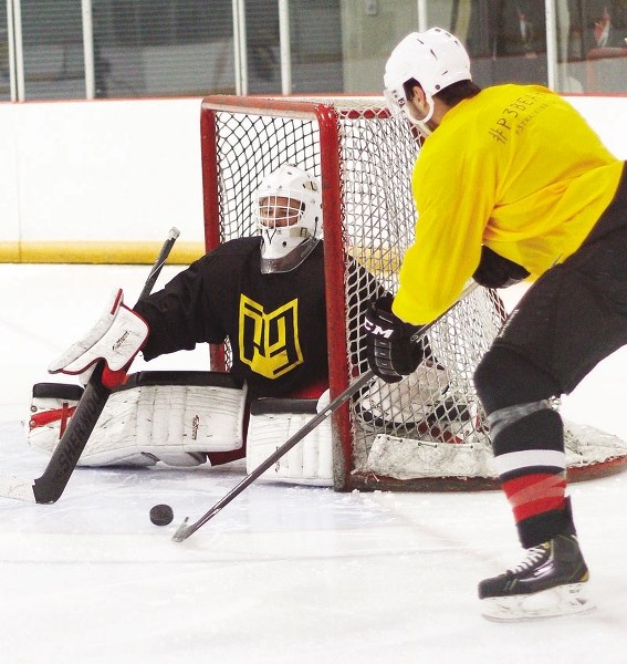Cochrane Generals goalie McKenzie Chalmers makes a save while working on his game at the NXT Level P3 hockey camp Aug. 7 at Spray Lake Sawmills Family Sports Centre. The