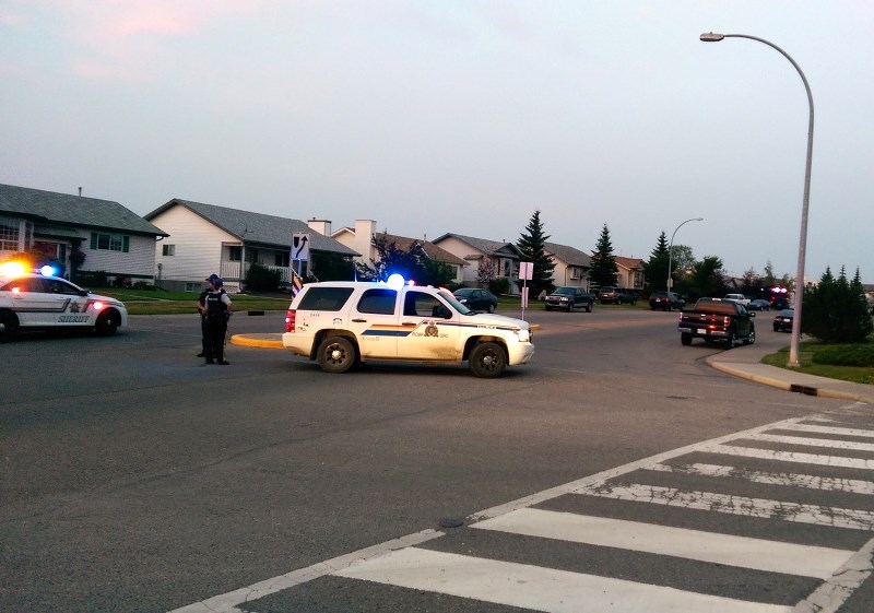 Police block off a section of Quigley Dr. as they attempt to bring a suspected armed man into custody Aug. 17.