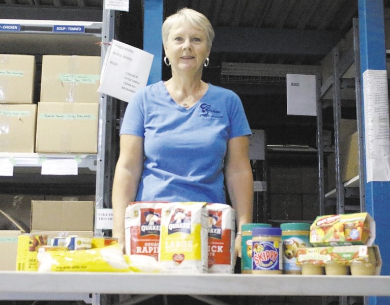 Ann Beatty, chair of the Activettes Food Bank committee, lays out some of the items that the local food bank is currently requesting donations for. The Activettes wish to