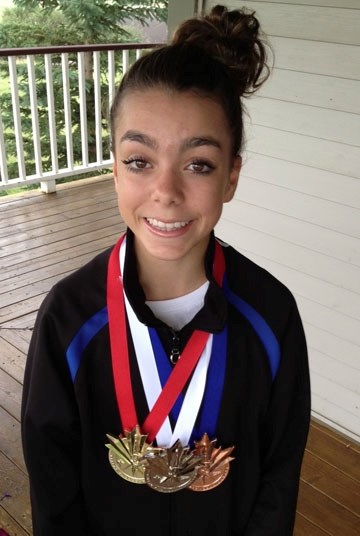 Cochrane diver Ashley McCool wears the medals she won at junior nationals Aug. 8-10 in Victoria. She&#8217;s diving for Canada at next month&#8217;s world junior meet in