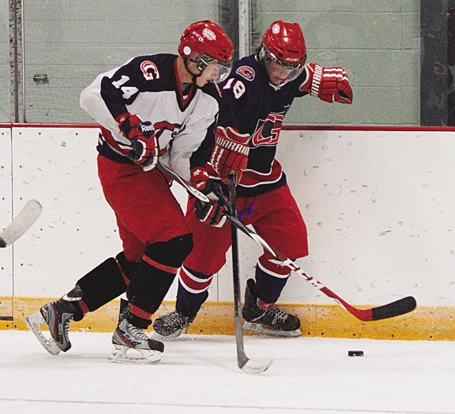 Returning veteran defenceman Logan Brown (left) tracks third-year sniper Ian McRae along the boards during Cochrane Generals training camp Day 2 at Spray Lake Sawmills Family 