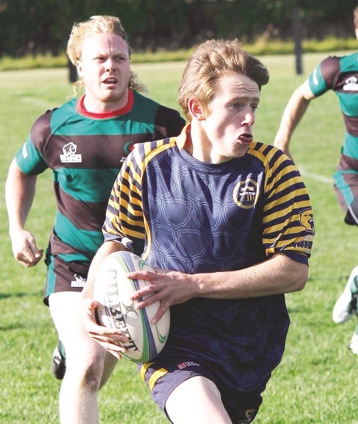 Bow Valley Grizzlies&#8217; Cam Birch sprints away with the ball in Calgary Rugby Union Div. 3 men&#8217;s opening-round playoff play Sept. 13 against Calgary Saracens. The