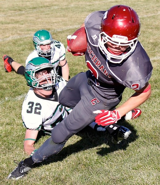 Cochrane High School Cobras slotback/running back Ethan Forrest works through Springbank Community High School Phoenix defence in 65-14 win Sept. 20 at Cochrane High Field.