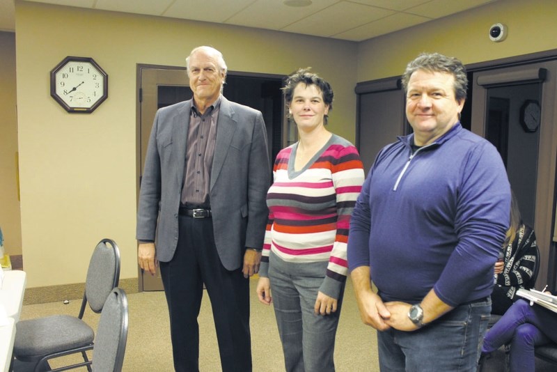 On Oct. 7 during a town council meeting at Redwood House, Mariska Span-Smeelan, middle, and Nick Chodyka, right, were sworn in by former Redwood Meadows mayor Tim Anderson as 