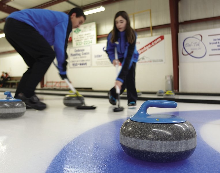 Young Cochranites curl at the current Curling Club.