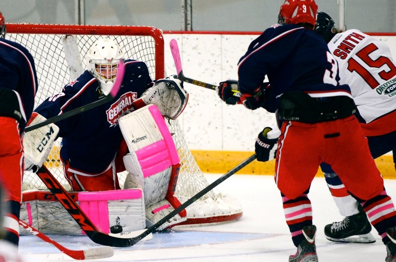 Okotoks Bisons forward Harrison Smith wrists a shot on Cochrane Generals goalie Garrett Iverson in Heritage Junior Hockey League play Oct. 18 in Cochrane.