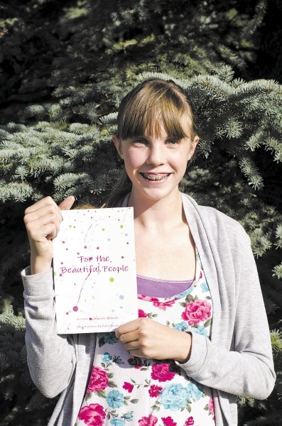 Hannah Godard holds the book she wrote, titled For the Beautiful People, in order to spread awareness about bullying and the effect it can have on people.