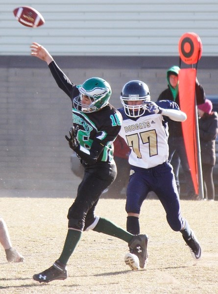 Bow Valley Bobcats defender Jadon Kibzey pressures Springbank Phoenix quarterback Jesse Schonacher in Rocky View Sports Association high school Division bronze-medal football 