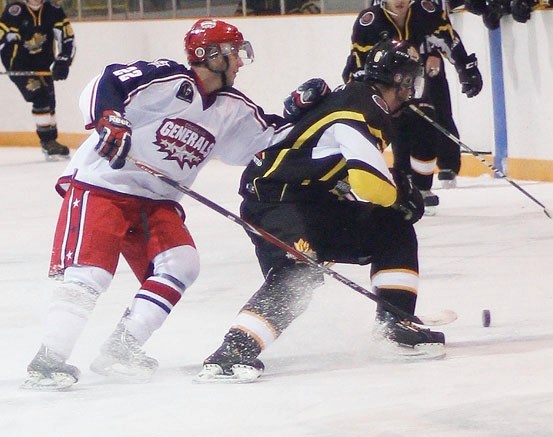 Cochrane Generals forward Dustin Boone harasses Strathmore Wheatland Kings defenceman Jesse Storrs in Heritage Junior Hockey League play Oct. 25 in Strathmore.