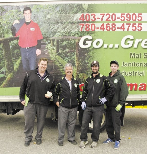 From left: Glen Smith, Kim Caron, Shayne Caron and Cody Boughton stand in front of the Executive Mat truck outside the Cochrane RancheHouse.