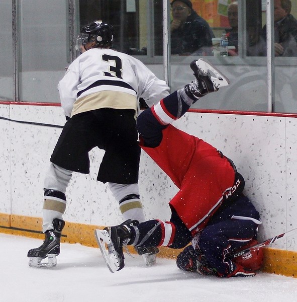 Cochrane Generals forward Steven Tisdale tries to unload on, but misses, Banff Bears defenceman Alex Prziblawsky-Bodo in Heritage Junior Hockey League play Nov. 8 at Spray