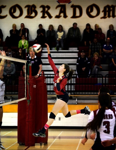 Cochrane Cobras Ali Leskow spike the ball in high school girl&#8217;s senior regional semifinal play. Leskow and the Cobras are playing in the Nov. 14-15 3A Zone girls