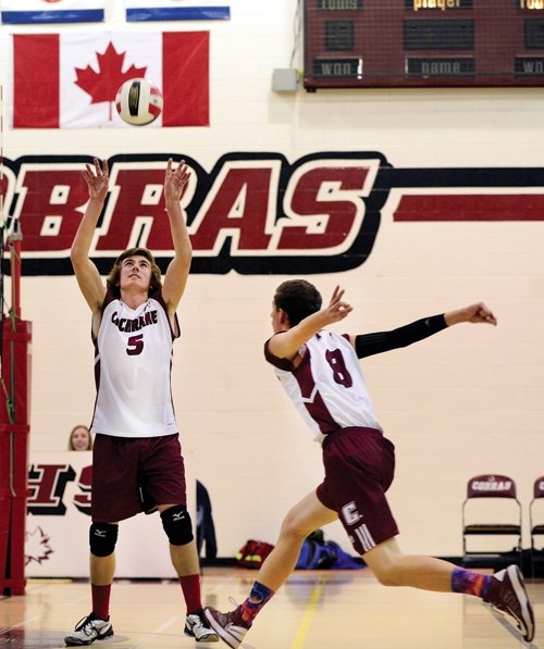 Cochrane Cobras setter Gord West sets for middle hitter Jake Nielson in Rocky View senior boy&#8217;s high school semifinal volleyball play. The Division-champion Cobras host 