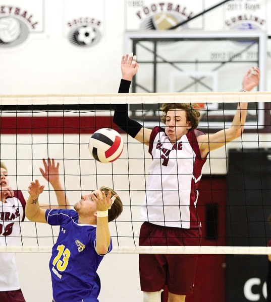 Cochrane Cobras&#8217; Nic Berscht puts up a block in Alberta Schools&#8217; Athletic Association South Central Zone 3A varsity boy&#8217;s volleyball tournament play against 
