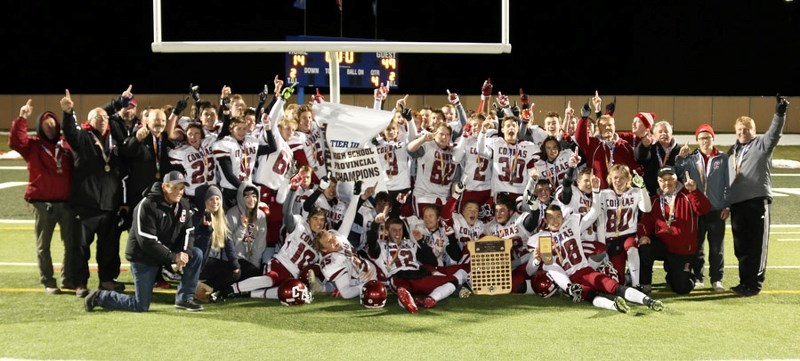 Cochrane High School Cobras football team celebrates its 2014 Alberta Schools&#8217; Athletic Association Tier 3 Alberta Bowl win Nov. 21 at Lethbridge University Stadium.