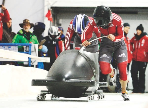 Cochrane&#8217;s Janine McCue pushes behind driver Christine de Bruin at North America&#8217;s Cup two-man women&#8217;s bobsleigh event at Calgary&#8217;s Canada Olympic