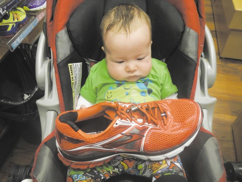 Grand-baby Matthew Connor checks out a pair of runners at the Running Room.