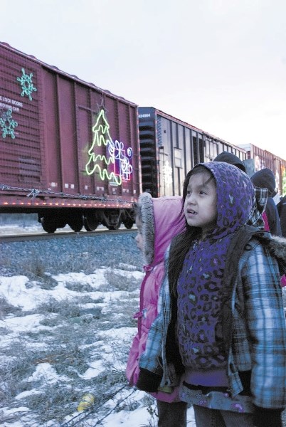 Rainy Kaquitts watches as the Canadian Pacific Holiday Train pulls into Morley at the Stoney Trading Post Dec. 13, 2012.