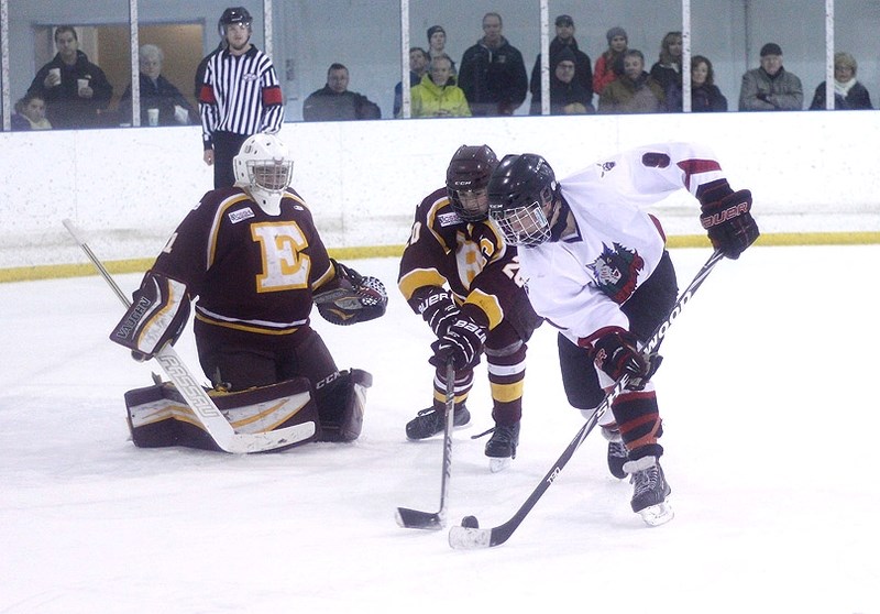 Bow Valley Timberwolves forward Brad Bergschoeff works the puck towards Edge School goalie Joshua Lund as Edge defenceman Carson Romerill arrives in South Central Alberta