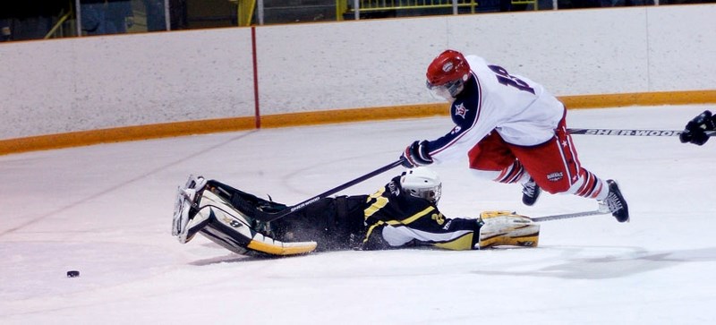 Cochrane Generals forward Corey Goeson coaxes the puck past Strathmore Wheatland Kings goalie Liam Banks for a goal Dec. 13 in Strathmore. The Wheatland Kings are in town for 