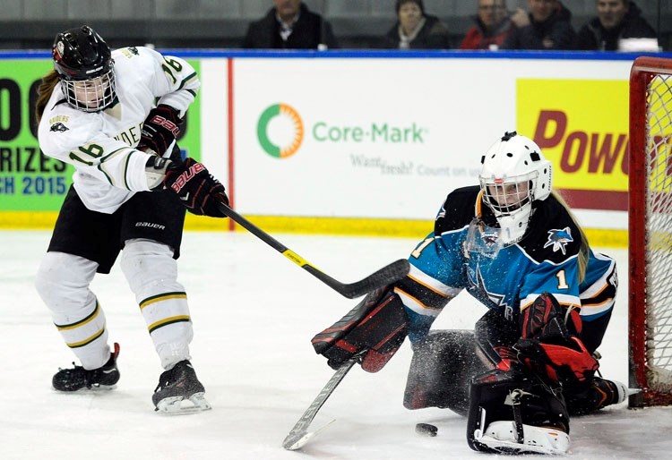 Rocky Mountain Raiders forward Jenna Wasylik of Cochrane feeds a shot at Battlefords Sharks goalie Chloe Marshall in Mac&#8217;s Major Midget AAA Hockey Tournament play