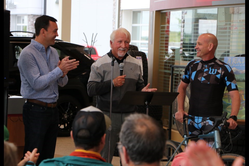 Airdrie-Cochrane MP Blake Richards, left, Trail Steering Committee member Dan Kroffat and Mayor Jeff Genung announce the winner of a friendly competition between the MP and the Mayor to see who could raise the most money for the Bike-A-Thon.