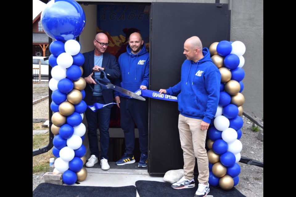 Cochrane Mayor Jeff Genung, Kieran Keddle, and Camille Sarisska (L-R) cutting the ribbon at the grand opening of Kieran Keddle Academy in downtown Cochrane on April 19. 