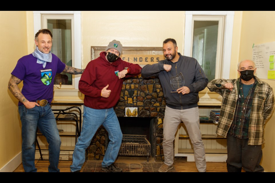 Wayfinders Wellness Retreat members present You and Yours Painting owner Omid Hedayat with the organization's Community Appreciation Award on Monday (Jan. 25). (Chelsea Kemp/The Cochrane Eagle)
