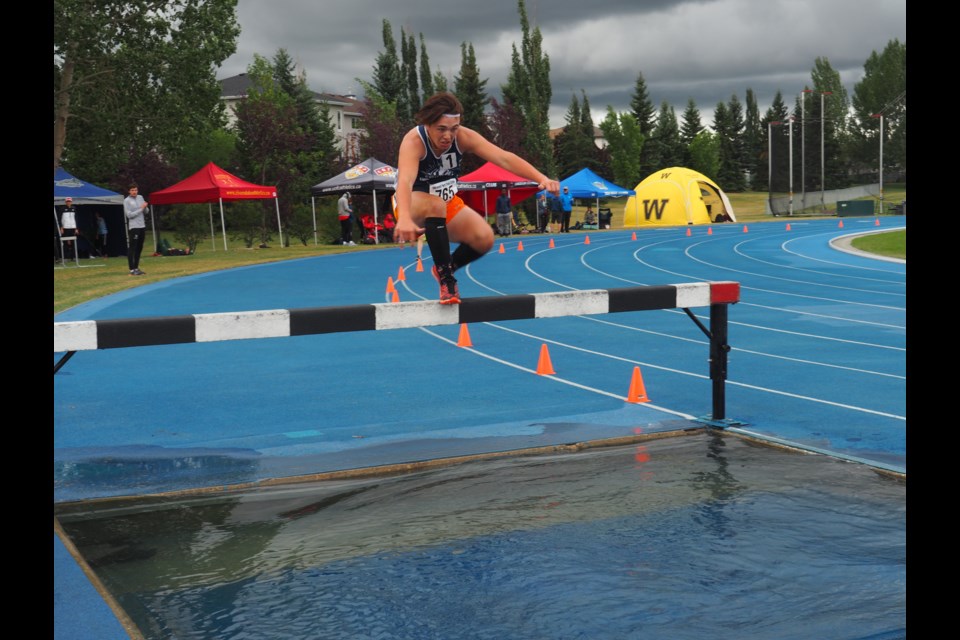 The Endurance Project's Brendan Maguire jumps over a pool of water in the men's steeplechase. Photo submitted.       